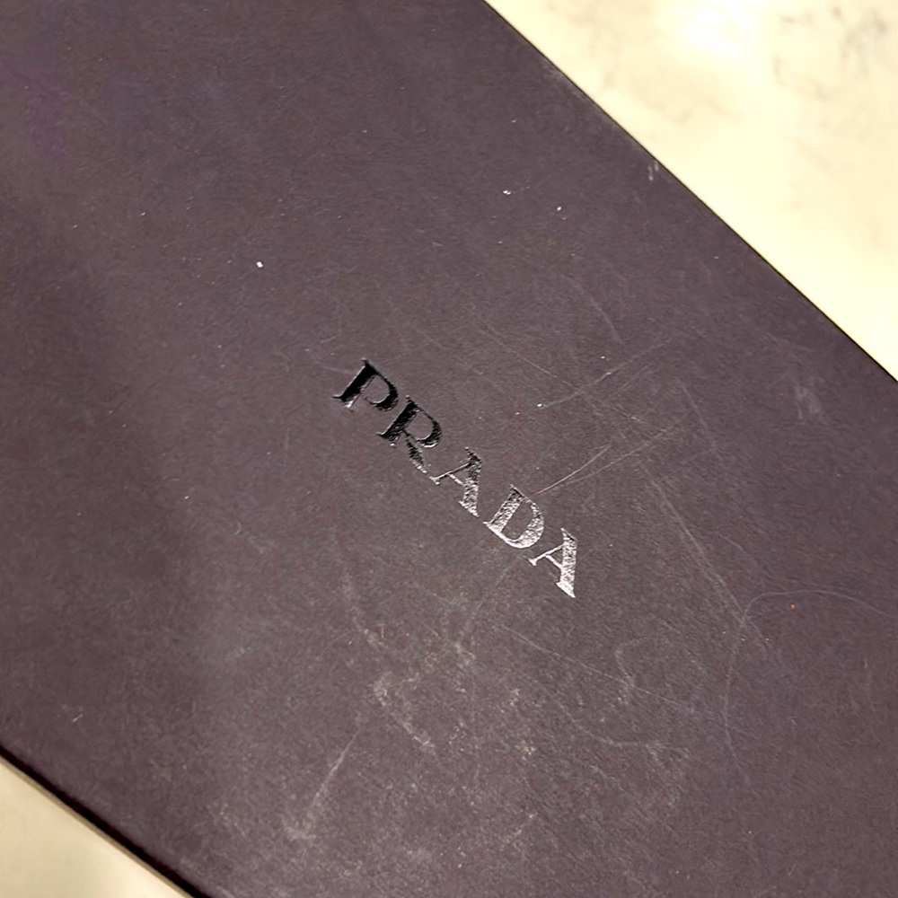 PRADA Vero Cuio Black Suede Pumps. Adorned with bold silver buckle.